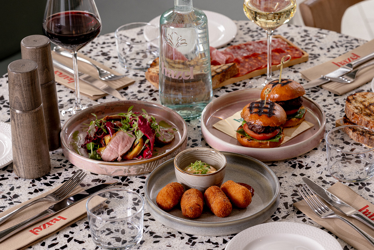 Three small plates of food with wine