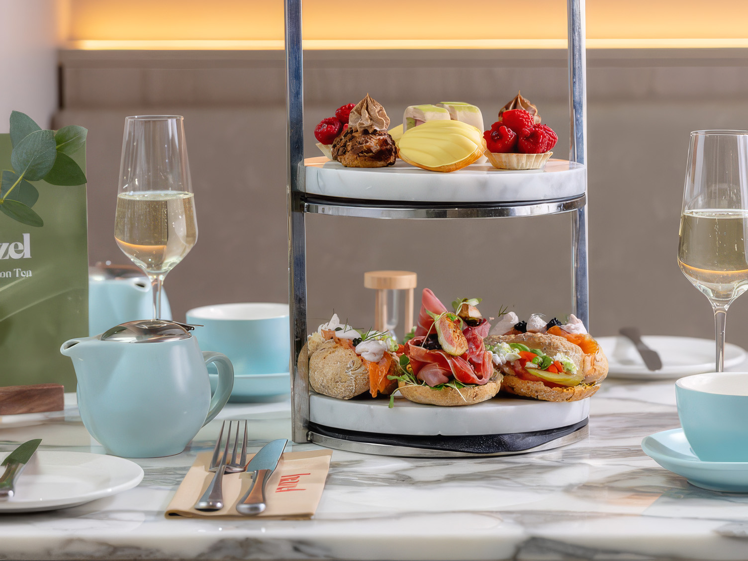 Champagne and Afternoon Tea stand full of cakes and sandwiches